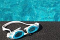 Blue swimming goggles on swimming pool Royalty Free Stock Photo