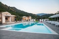 Blue swimming pool in a spa hotel in southern Italy at sunset Royalty Free Stock Photo