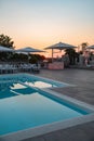 Blue swimming pool in a spa hotel in southern Italy at sunset Royalty Free Stock Photo