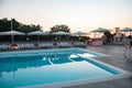 Blue swimming pool in a spa hotel in southern Italy at sunset Royalty Free Stock Photo