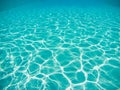 Blue swimming pool underwater with bright sun light reflections or caustics, background or texture