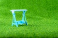 Blue Swings put on the green grass in the park or garden