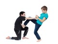 In the blue T-shirt boy is doing armlock on a boy in a black T-shirt Royalty Free Stock Photo