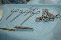 On the blue table in the operating room is a sterile set of stainless steel surgical instruments. Preparation of surgery Royalty Free Stock Photo