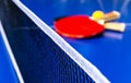 Blue table tennis or ping pong. Close-up ping-pong net. Close up ping pong net and line. Two table tennis or ping pong rackets or Royalty Free Stock Photo