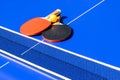 Blue table tennis or ping pong. Close-up ping-pong net. Close up ping pong net and line. Two table tennis or ping pong rackets orB Royalty Free Stock Photo