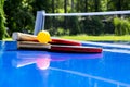 Blue table tennis or ping pong. Close-up ping-pong net. Close up ping pong net and line. Two table tennis or ping pong rackets or Royalty Free Stock Photo