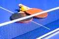 Blue table tennis or ping pong. Close-up ping-pong net. Close up ping pong net and line. Two table tennis or ping pong rackets or Royalty Free Stock Photo