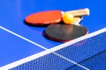 Blue table tennis or ping pong. Close-up ping-pong net. Close up ping pong net and line. Two table tennis or ping pong rackets or Royalty Free Stock Photo