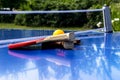 Blue table tennis or ping pong. Close-up ping-pong net. Close up ping pong net and line. Two table tennis or ping pong rackets or Royalty Free Stock Photo