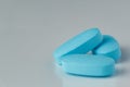 blue tablets on a light background, vitamins and medicines Royalty Free Stock Photo