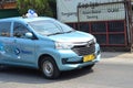 blue taxi in at the road in bekasi, famous taxi in indonesia