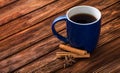 Blue tea cup on an old wooden surface. Old brown boards. Cinnamon sticks and anise near the cup. The concept of home warmth and Royalty Free Stock Photo