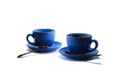 Blue tea cups and tea saucers with iron teaspoons on white background Royalty Free Stock Photo