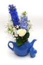 Blue teapot with bouquet Royalty Free Stock Photo