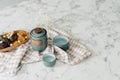 Blue teapot set next on marble table