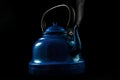 Blue teapot with steam .