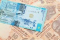 A blue tenge note from Kazakhstan with Indian ten rupee bank notes