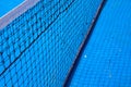Blue tennis court with black net. Empty sport field photo. Hard court cover for lawn tennis. Summer sport activity Royalty Free Stock Photo