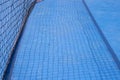 Blue tennis court with net shadow. Empty sport field photo. Hard court cover for lawn tennis. Summer sport activity Royalty Free Stock Photo
