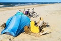 Blue tent and bicycles on wild deserted sandy beach. Camp at the Baltic sea coast. Bicycle tourism. Royalty Free Stock Photo