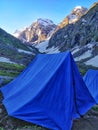 Blue tent in a campsite on a very pretty valley in Indian Himalayan Mountains. Hiking and camping on Hampta pass trek in India. Royalty Free Stock Photo