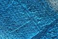 Blue texture of a piece of crumpled foil