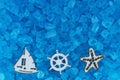 Blue textured beach glass with ocean objects closeup background