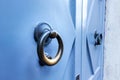 Blue textured door with circular gold metal handle Royalty Free Stock Photo