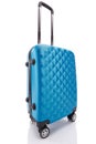 Blue textured wheeled colorful travel bag with handle isolated on white. Royalty Free Stock Photo