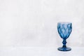 Blue textured wine glass on a concrete background Royalty Free Stock Photo