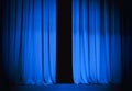 Blue theatre stage curtain slightly open