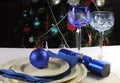 Blue theme Christmas table setting in front of Christmas Tree