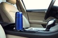 Blue thermos in holder inside of car