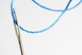 Blue thread going through needle eye close-up Royalty Free Stock Photo