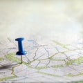 Blue thumbtack marking and showing destination location point on map background with copy space Royalty Free Stock Photo