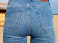 blue tight jeans on female buttocks, close-up from behind Royalty Free Stock Photo