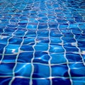 Blue tiled pool creates abstract backdrop with serene rippling aqua reflections