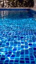 Blue tiled pool creates abstract backdrop with serene rippling aqua reflections