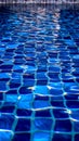 Blue tiled pool creates abstract backdrop with serene rippling aqua reflections Royalty Free Stock Photo