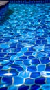 Blue tiled pool creates abstract backdrop with serene rippling aqua reflections