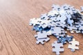 blue tiles of a puzzle on a wooden table. Concept to indicate le