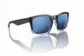 Blue tinted sunglasses with black frames on white background Royalty Free Stock Photo