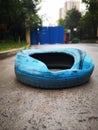 Blue tire lying on the ground Royalty Free Stock Photo