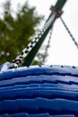 blue tire swing and chain shot from bottom Royalty Free Stock Photo