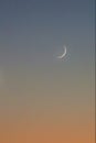 Blue to orange crescent moon twilight