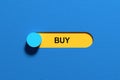 Blue toggle switch turning on buy option on yellow background