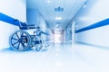 Blue tone of empty wheelchair on hospital or clinic corridor or hallway with light tunnel. Royalty Free Stock Photo