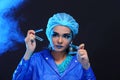 Blue Tone Fashion Scientist in Dark room laboratory with tools l