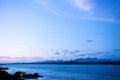 Blue tone sunset sky over Mae Khong river in Nakhon Phanom. Natural border between Thailand and Laos Royalty Free Stock Photo